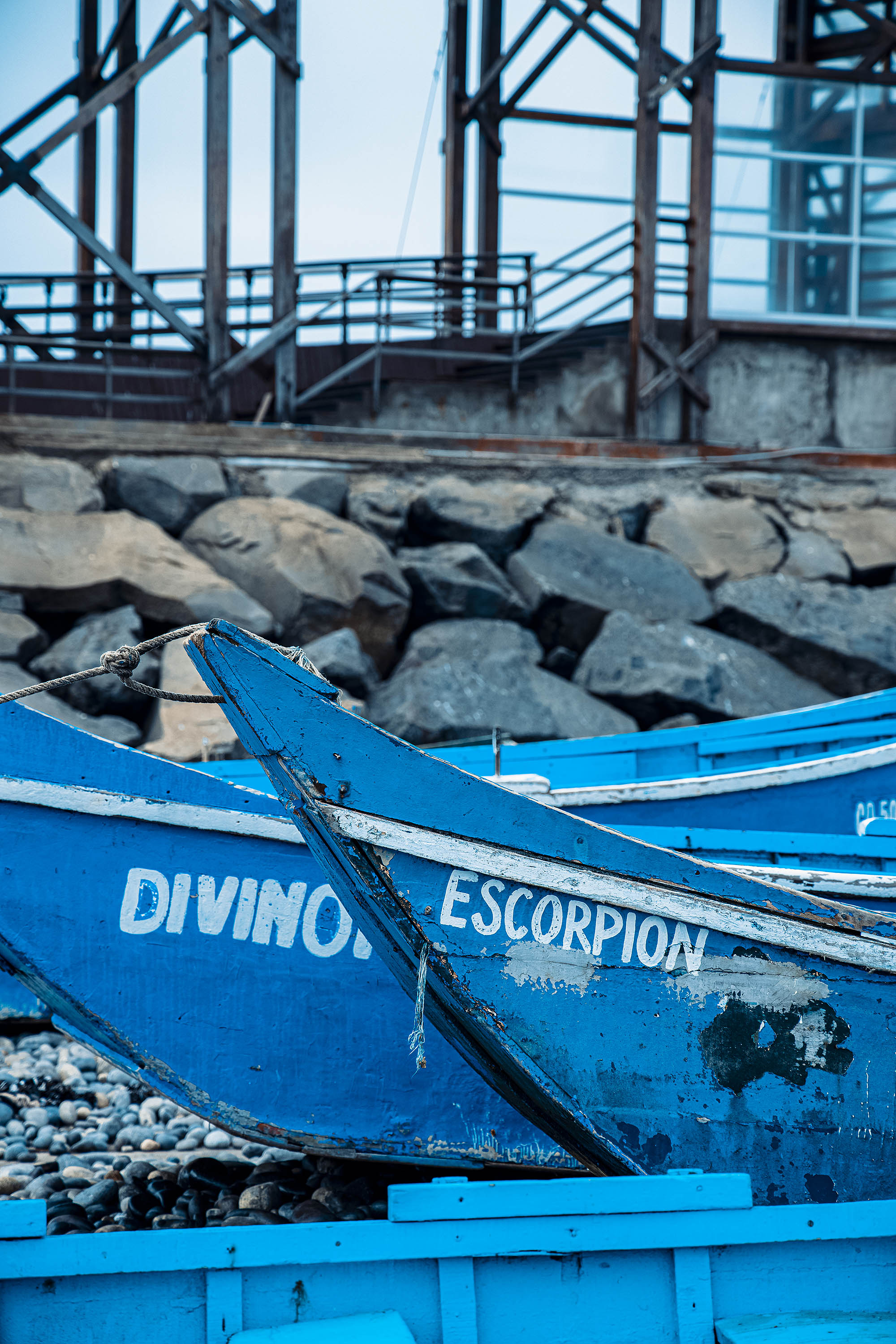 Photographie de deux barques en bois bleues avec inscriptions écrites sur l'avant 